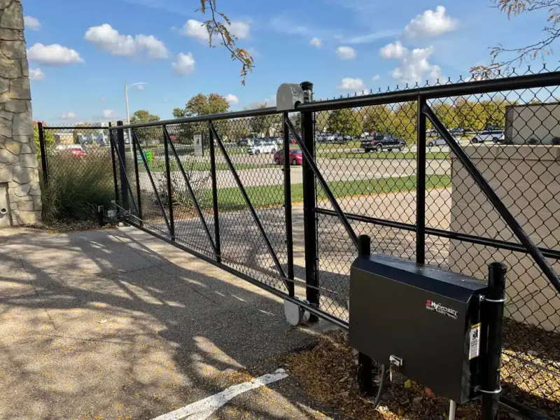 Automated chain link slide gate with an electric gate operator at a commercial property