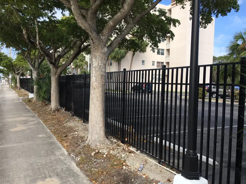 Black aluminum tubular fence installed along the perimeter of a South Florida apartment complex