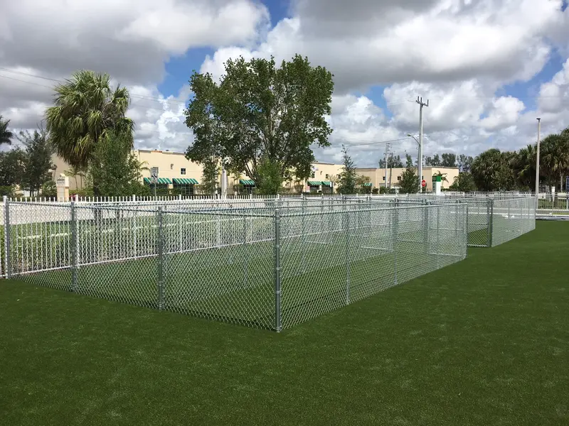 Galvanized chain link dog park enclosures on commercial turf — South Florida