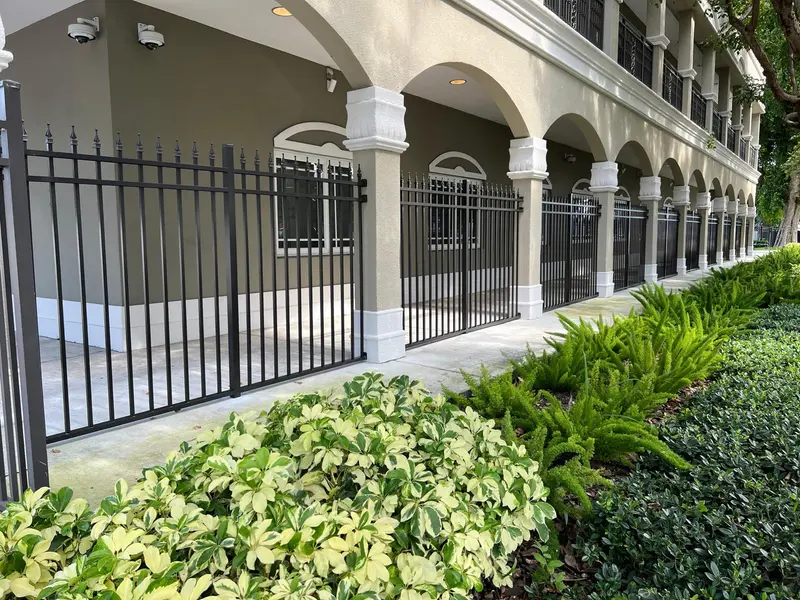 Ornamental black aluminum fence installed in front of an upscale South Florida commercial building