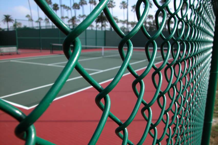 Chain link fence enclosure around a South Florida sports court