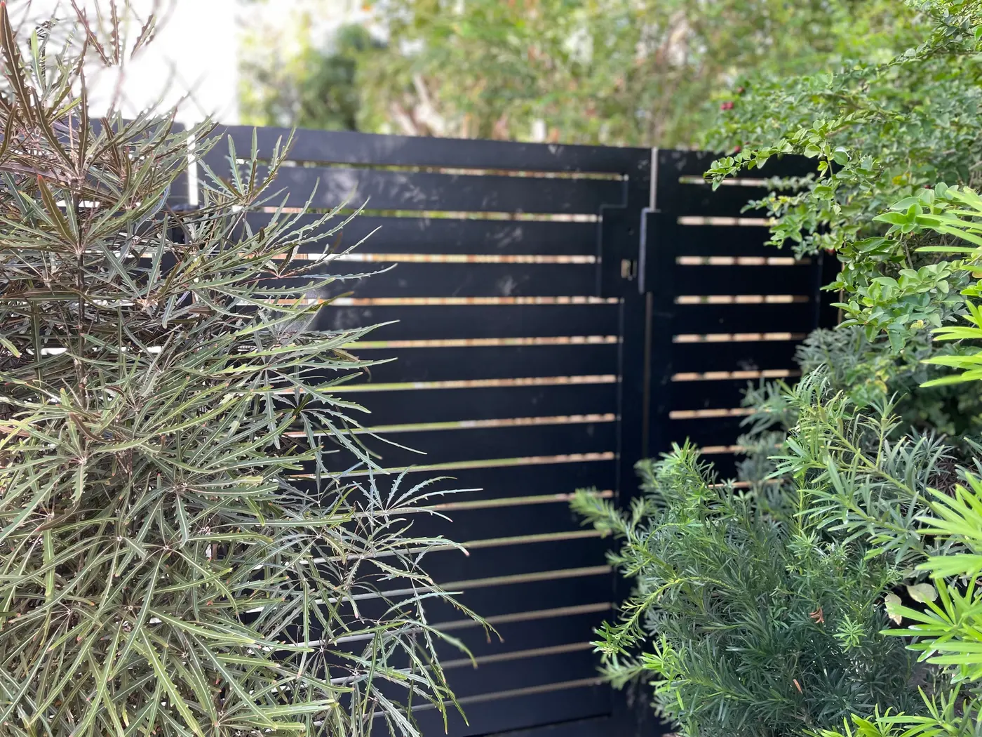 Custom black aluminum horizontal-slat fence, South Florida