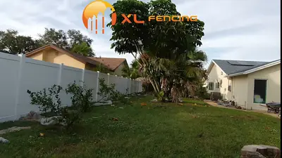 White PVC vinyl privacy fence installation in a South Florida backyard