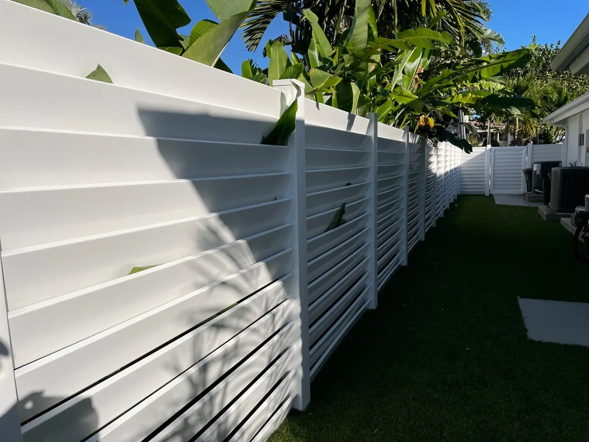 Louvered vinyl fence with angled slats installed in South Florida